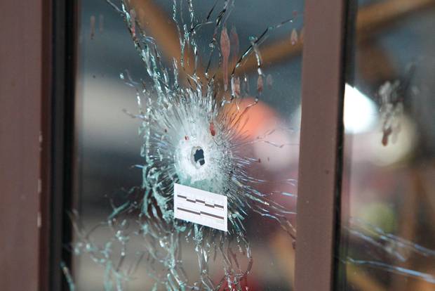 Bullet holes are visible in La Casa Nostra pizzeria Paris one of the venues for the attacks in the French capital. The death toll among Britons is expected to rise and the total loss of life in the atrocity has been revised up to at least 129 with 352