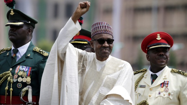 Nigerian President Muhammadu Buhari salutes his supporters during his Inauguration in Abuja Nigeria in May