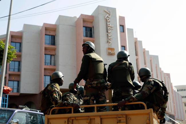 Soldiers from the presidential patrol outside the Radisson Blu hotel in Bamako Mali Saturday Nov. 21 2015 in anticipation of the President's visit