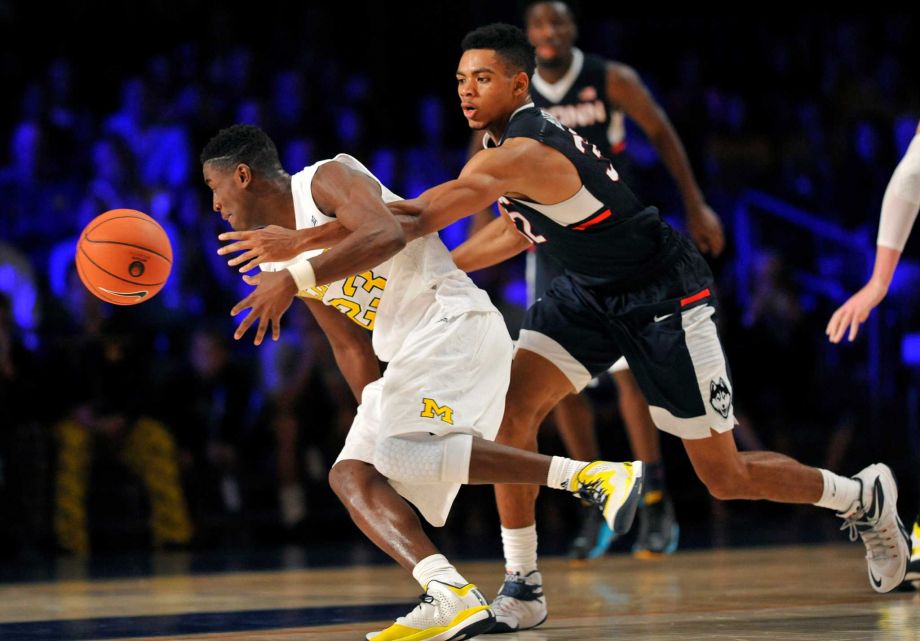 Connecticut forward Shonn Miller pokes the ball away from Michigan guard Caris Le Vert during an NCAA college basketball game Wednesday Nov. 25 2015 in Paradise Island Bahamas