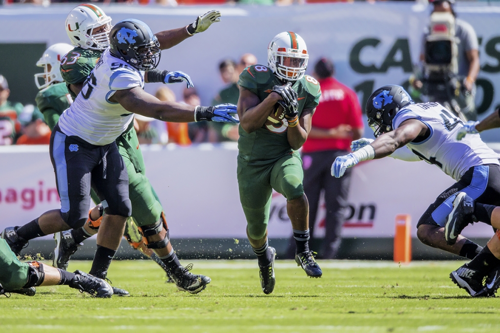 Former running back Duke Johnson runs past two North Carolina defenders during last year's win against the Tar Heels. File