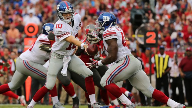 TAMPA FL- NOVEMBER 08 Eli Manning #10 of the New York Giants hands off to Andre Williams #44 during a game against the Tampa Bay Buccaneers at Raymond James Stadium