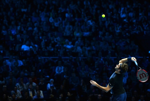 Switzerland's Roger Federer serves to Serbia's Novak Djokovic during their men's singles group stage match on day three of the ATP World Tour Finals tennis