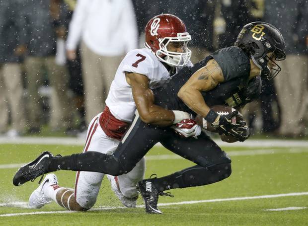 OU's Jordan Thomas brings down Baylor's Lynx Hawthorne in the Sooners 44-34 victory last Saturday