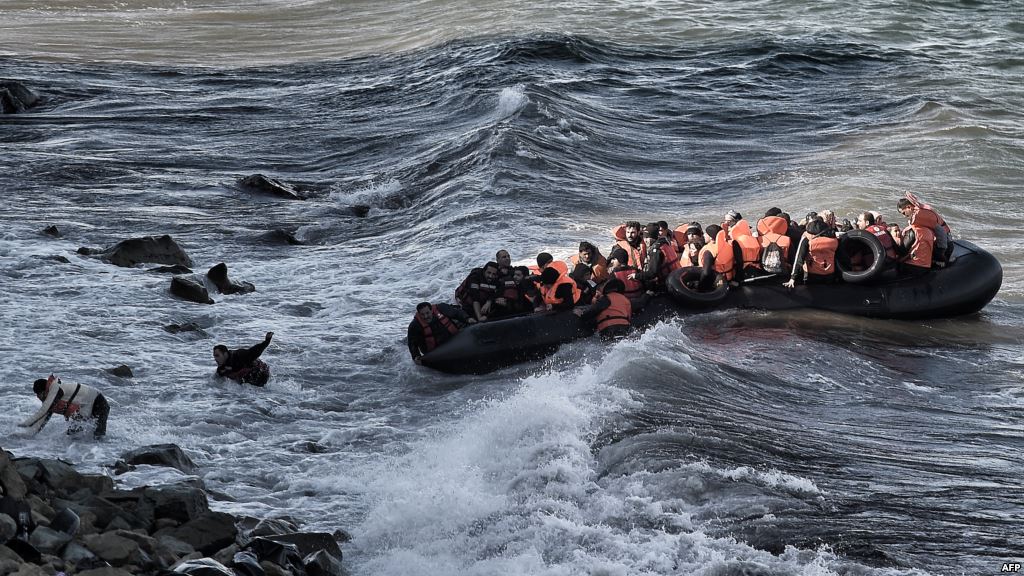 Refugees and migrants try to reach the shore on the Greek island of Lesbos despite a rough sea after crossing the Aegean Sea from Turkey Oct. 30 2015