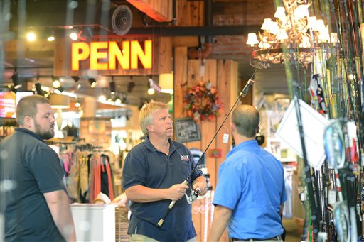 Nov. 27 2015 Danny Smith and his son Johs left look over fishing rods as they talk with Josh Johnson a Neuse Sport Shop employee in Kinston N.C