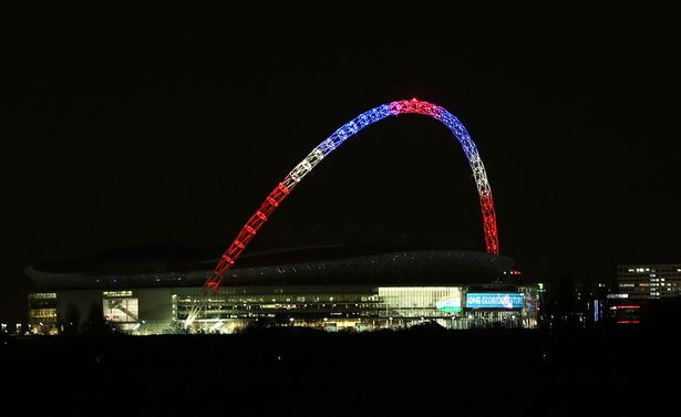 The arch of Wembley Stadium London is lit in the colours of the Union flag