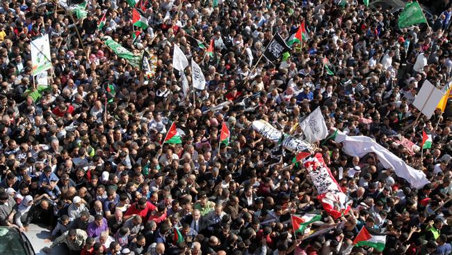 Palestinian mourners wave flags as they carry the bodies of five Palestinians killed by Israeli forces during a funeral procession in the occupied West Bank city of al Khalil