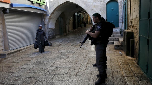 An Israeli border police officer secures the area in Jerusalem's Old City where Israeli border police shot dead a Palestinian who stabbed an officer on Sunday. It was latest attack in a two-month wave of violence