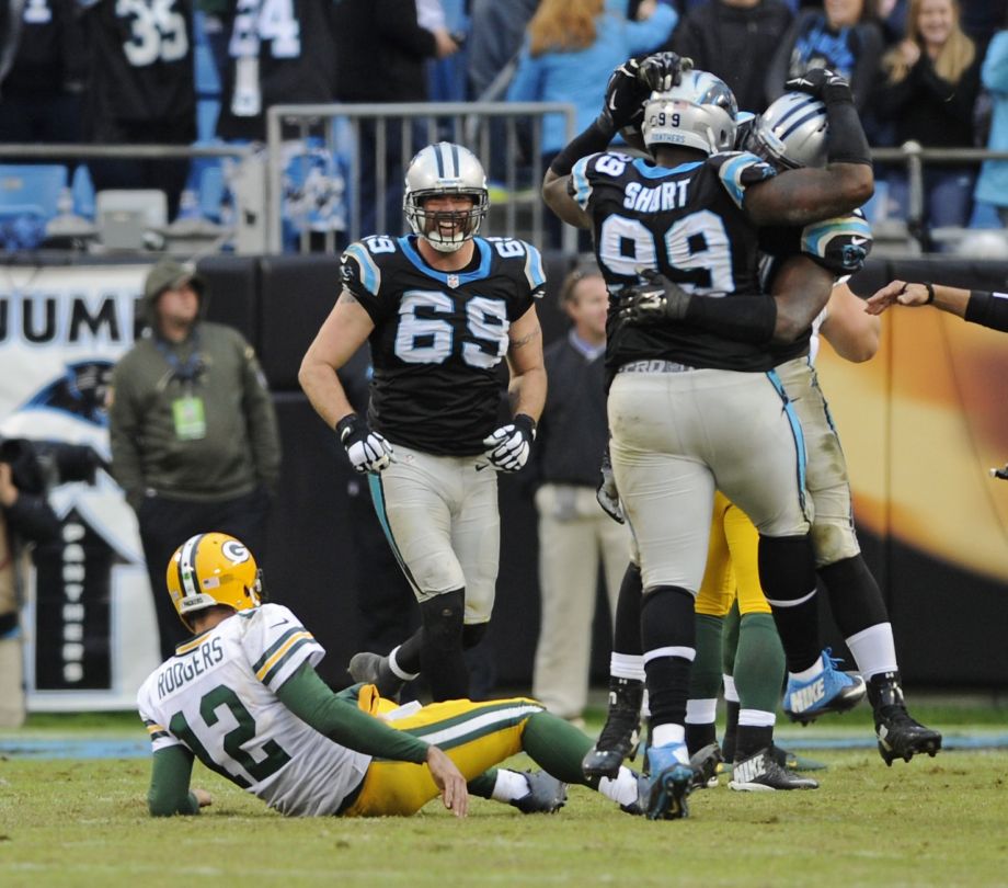 Carolina’s Kawann Short embraces a teammate after a second-half sack of Green Bay’s Aaron Rodgers