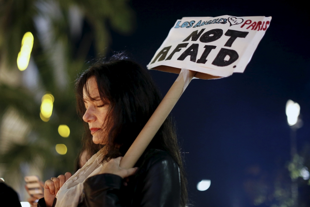 People gather for a vigil outside the French Consulate in response to the attacks in Paris in Los Angeles California United States