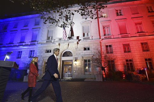 US Secretary of State John Kerry next to US Ambassador to France Jane D. Hartley leaves after delivering a speech outside the US Embassy illuminated with the colors of the French national flag in Paris Monday Nov. 16 2015. John Kerry will meet Frenc