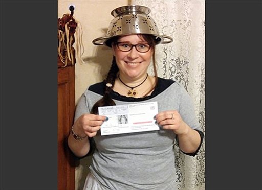 Fauvel Lindsay Miller of Lowell Mass. wears a spaghetti strainer to reflect her religious beliefs while holding her temporary driver license that also bears