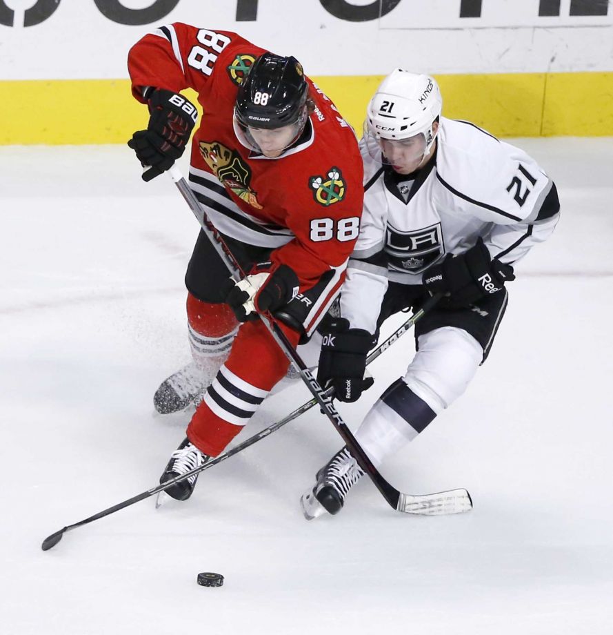 Chicago Blackhawks right wing Patrick Kane and Los Angeles Kings center Nick Shore battle for the puck during the first period of an NHL hockey game Monday Nov. 2 2015 in Chicago