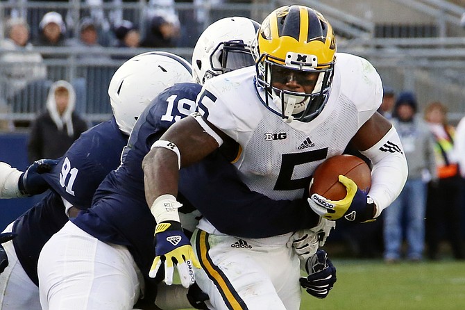 Michigan quarterback John O'Korn is tackled by Penn State defensive end Torrence Brown during the second half in State College Pa. Saturday Nov. 21 2015. Michigan won 28-16