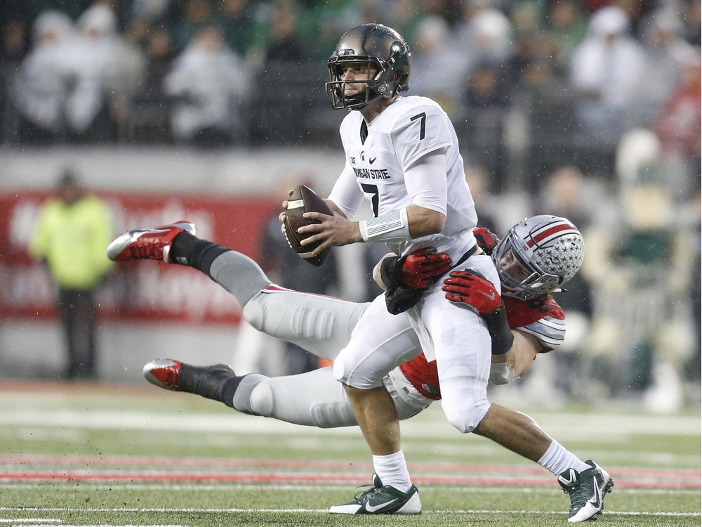 A key to Saturday's game likely will be how much pressure Buckeyes defensive end Joey Bosa can get on Michigan QB Jake Rudock once a teammate at St. Thomas Aquinas in Fort Lauderdale Fla.
Here Bosa pressures MSU quarterback Tyler O'Connor (7