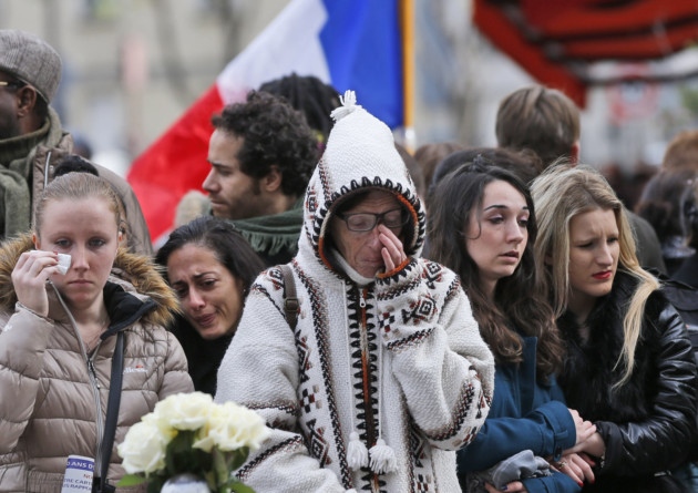 People pay respect to the victims in front of the Carillon Restaurant in Paris where terrorists attacked on Friday