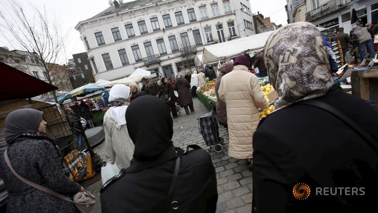 People shop at a market in the neighbourhood of Molenbeek in Brussels Belgium