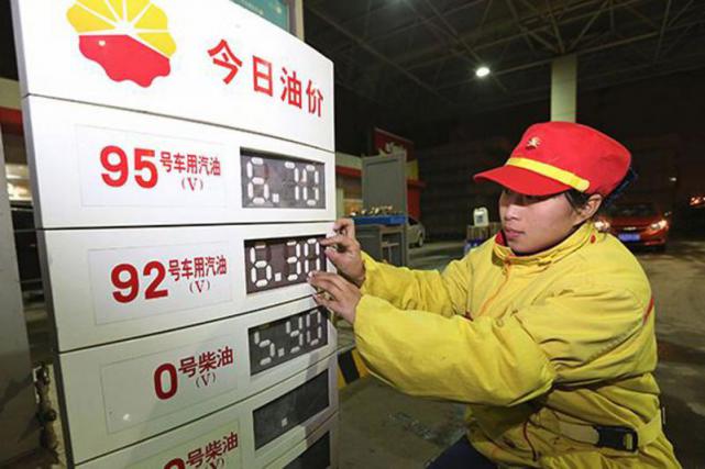 An employee at a Petro China Co Ltd gas station in Nanjing capital of Jiangsu province alters oil