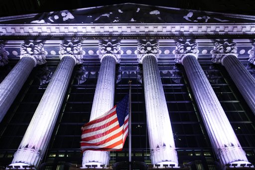 American flag flies in front of the New York Stock Exchange. Global stock markets mostly fell on Thursday Oct. 29 2015 after Federal Reserve policymakers left the U.S. benchmark rate at a record low but indic