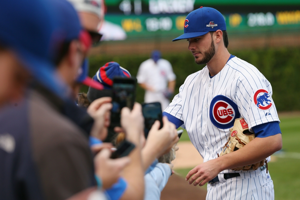 CHICAGO IL- OCTOBER 13 Kris Bryant #17 of the Chicago Cubs signs autographs prior to game four of the National League Division Series between the Chicago Cubs and the St. Louis Cardinals at Wrigley Field