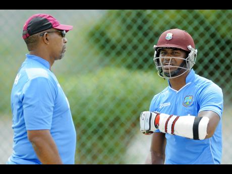 Marlon Samuels speaks with head coach Phil Simmons