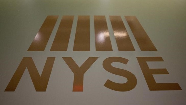 A New York Stock Exchange logo is displayed on the floor of the New York Stock Exchange