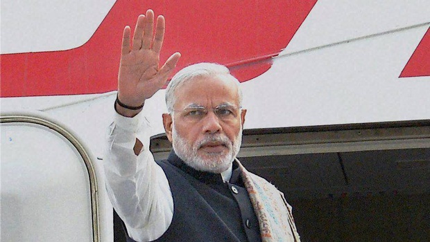 Prime Minister Narendra Modi waves before his departure for France to attend the Paris Climate Conference at AFS Palam in New Delhi. | PTI