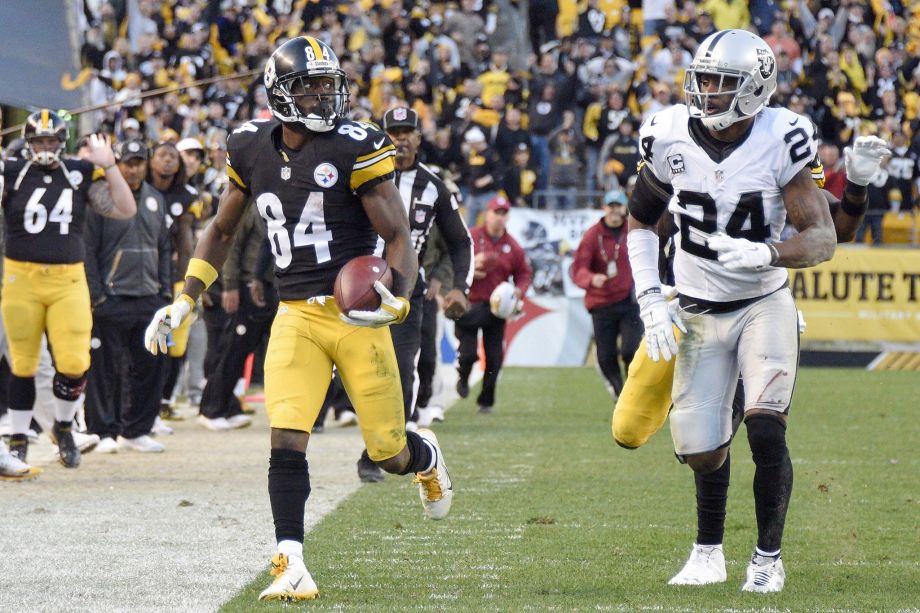 Pittsburgh Steelers wide receiver Antonio Brown runs past Oakland Raiders free safety Charles Woodson after making a catch to help set up the Steelers game-winning field goal in the second half of an NFL football game Sunday Nov. 8 2015 in Pi