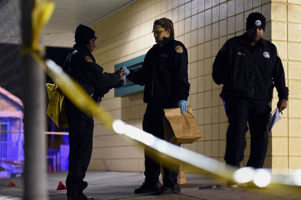 Image Police gather evidence after a shooting at a playground