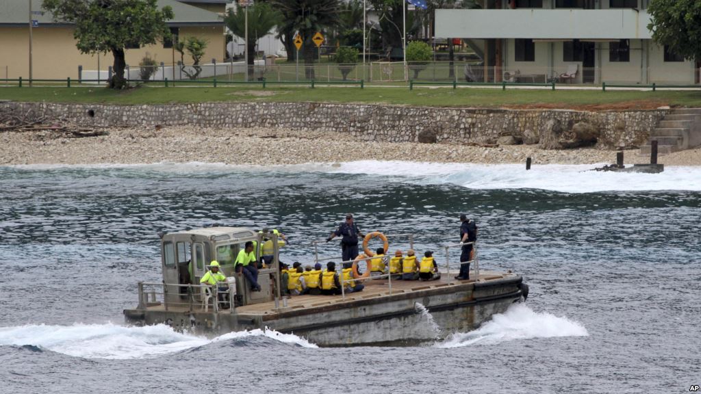 FILE- A group of Vietnamese asylum seekers are taken by barge to a jetty on Australia's Christmas Island. Australian officials said police regained control of the center after negotiating with the inmates but added it had to use 'some force&#39