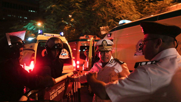 Police officers make way for ambulances with bodies of Russian plane crash victims outside Zeinhom morgue in Cairo Egypt. Image AP