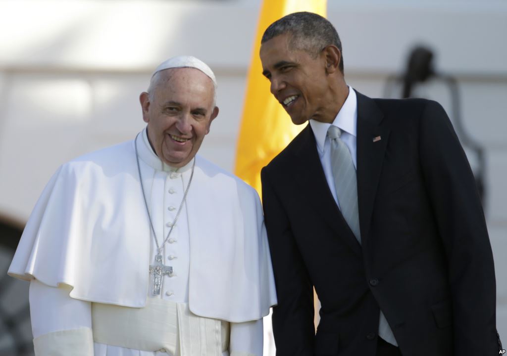 FILE- President Barack Obama leans over to talk to Pope Francis during a state arrival ceremony on the South Lawn of the White House in Washington Sept. 23 2015