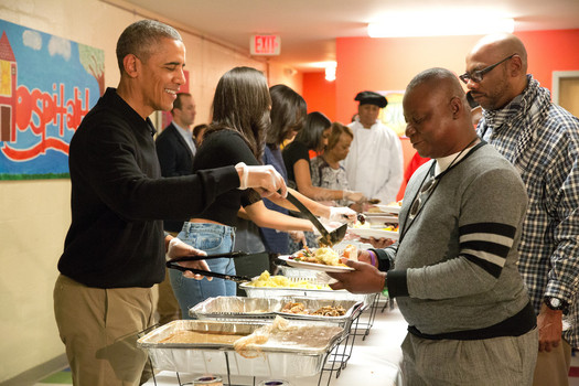 President Obama seen serving the poor at a shelter said we must welcome refugees with arms wide open