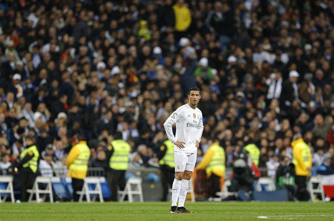 Real Madrid's Cristiano Ronaldo looks on as Barcelona's Andres Iniesta celebrates after scoring his side’s third goal during the first clasico of the season between Real Madrid and Barcelona at the Santiago Bernabeu stadium in Madrid Spain Saturday N