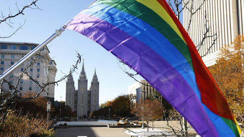 Pride flag flies in front of the Salt Lake Temple in Salt Lake City during the