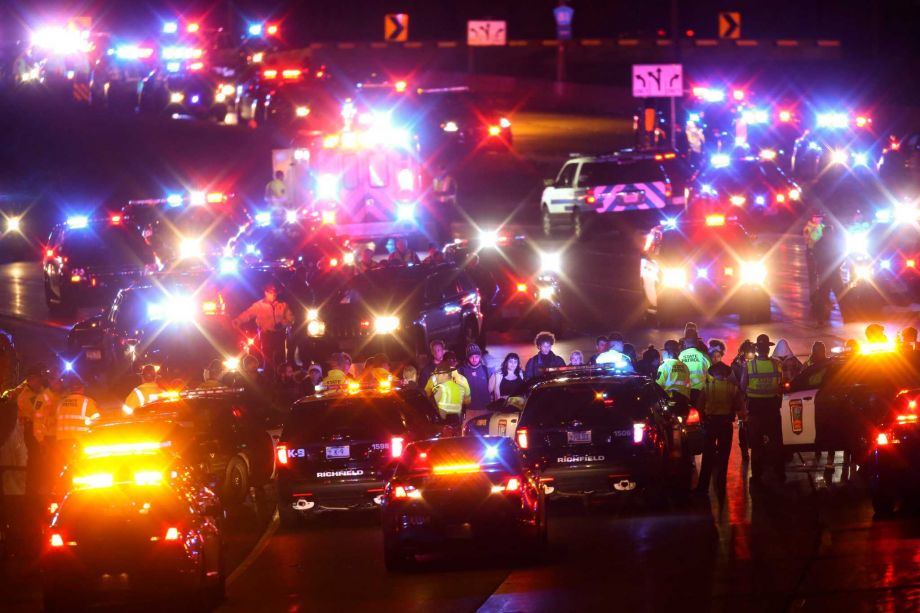 Demonstrators block a portion of Interstate 94 Monday Nov. 16 2015 in Minneapolis. The mayor of Minneapolis on Monday asked for a federal civil rights investigation into the weekend shooting of a black man by a police officer during an apparent strugg