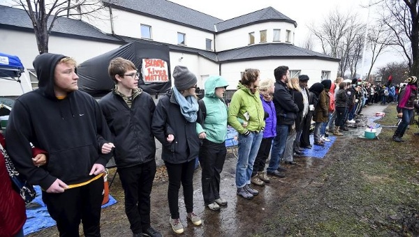 Demonstrators form a human chain in front of a north police precinct and around their protest encampment in Minneapolis Minnesota