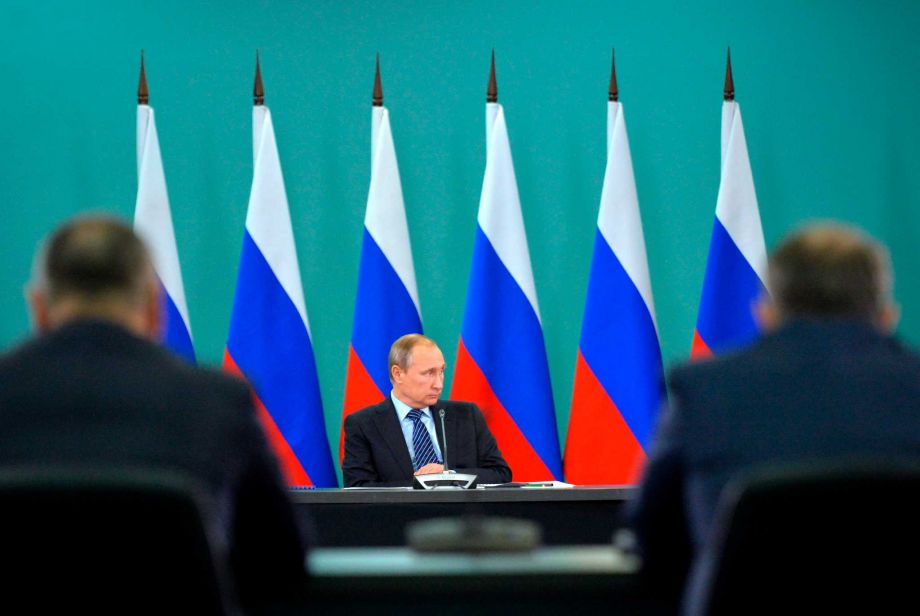 Russian President Vladimir Putin listens during his late-night meeting with the heads of Russia's sports federations in the Black Sea resort of Sochi Russia Wednesday Nov. 11 2015. Putin has ordered an investigation into allegations of widespread dopi