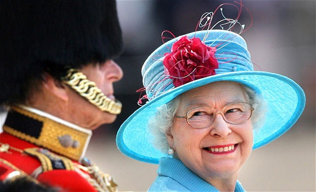 Queen Elizabeth II smiles with the Duke of Edinburgh on Horse Guards Parade during the annual Trooping the Colour parade. PRESS ASSOCIATION