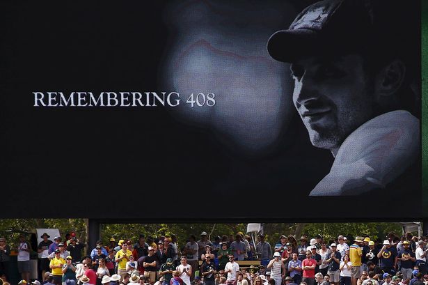 A tribute to former Australian cricketer Phillip Hughes who was the 408th player for Australia is displayed on a screen. Friday's opening day of the first day-night test match falls a year to the day that Hughes died from a serious head injury