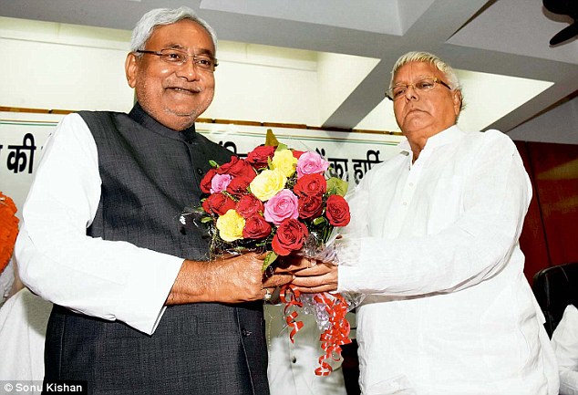 RJD chief Lalu Prasad presents a bouquet to JD ’s Nitish Kumar in Patna