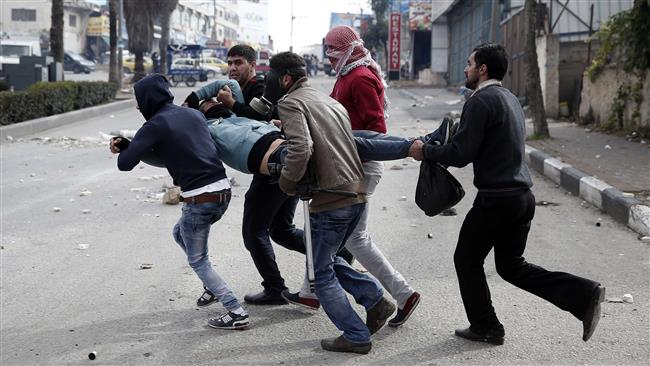 Palestinian demonstrators carry an injured man during clashes with Israeli forces in the occupied West Bank city of al Khalil