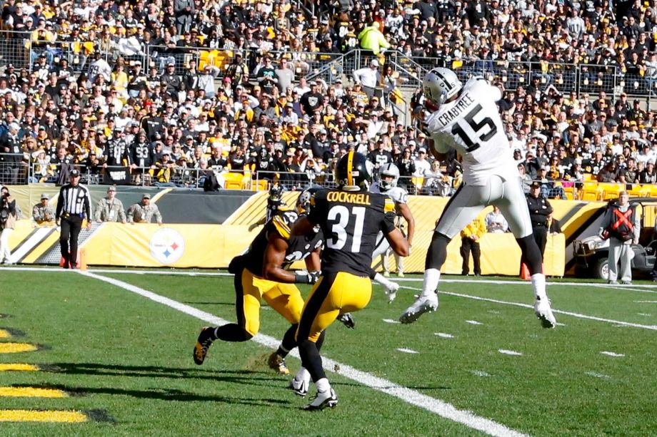 Oakland Raiders wide receiver Michael Crabtree makes a touchdown catch in front of Pittsburgh Steelers defensive back Ross Cockrell and free safety Mike Mitchell in the first quarter of an NFL football game Sunday Nov. 8 2015 in Pittsbu