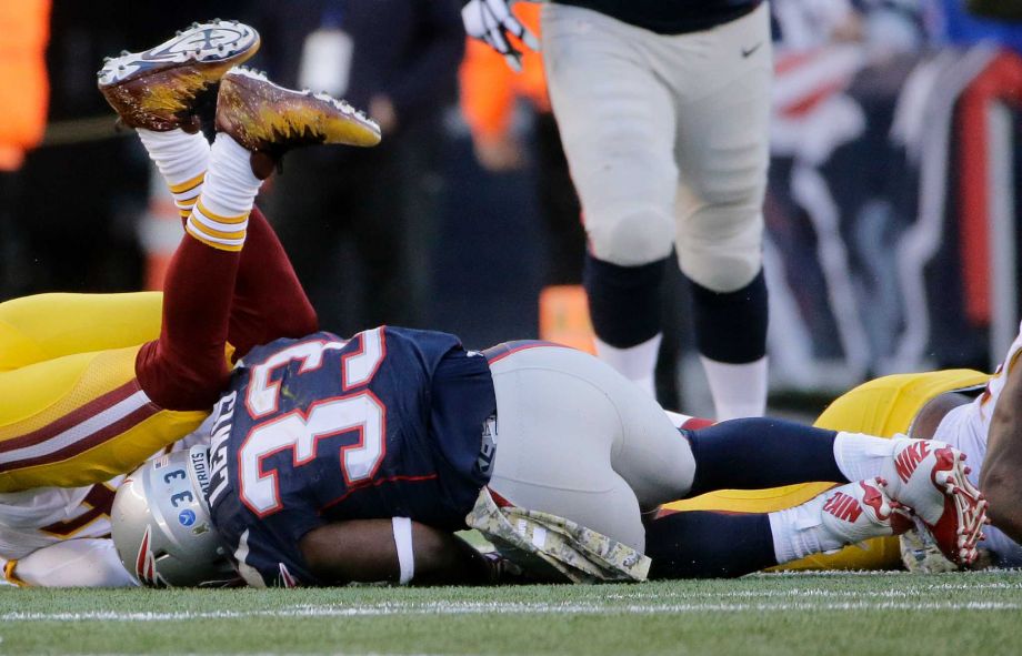 New England Patriots running back Dion Lewis lands on the turf during a play when he was injured during the second half of an NFL football game against the Washington Redskins in Foxborough Mass. Lewis left