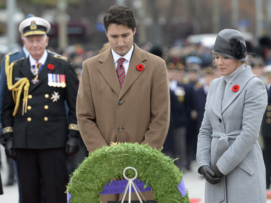 Prime Minister Justin Trudeau and Sophie Gregoire Trudeau look on after placing a wreath during the Remembrance Day ceremony as Gov.-Gen. David Johnston looks on at left