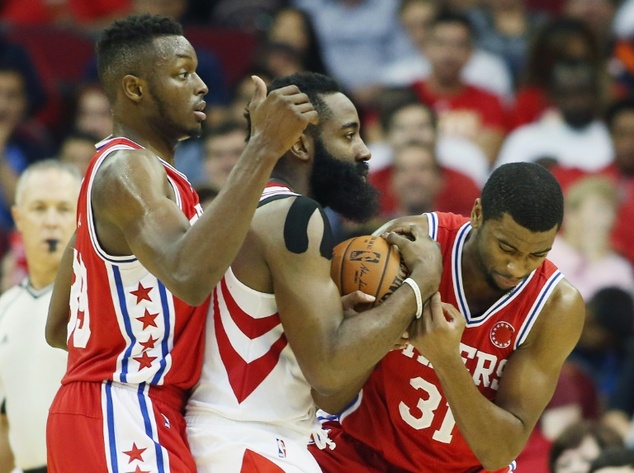 Houston Rockets James Harden battles with Philadelphia 76ers Hollis Thompson and Jerami Grant during their game at the Toyota Center