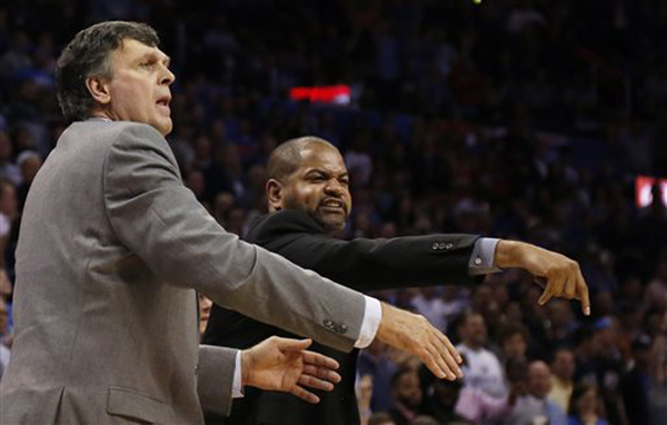 Houston Rockets head coach Kevin McHale left and assistant coach J.B. Bickerstaff right gesture in the fourth quarter of an NBA basketball game against the Oklahoma City Thunder in Oklahoma City. A person fami