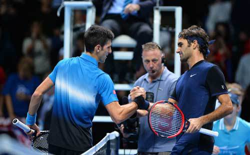 Switzerland’s Roger Federer shakes hands with Serbia’s Novak Djokovic after winning his men’s singles group stage match on day three of the ATP World Tour Finals tennis tournament in London on Wednesday. AFP