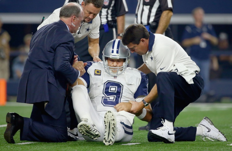 Getty  AFP  File  Tom Pennington Tony Romo of the Dallas Cowboys is assisted off the field by team medical personnel after being injured on a play against the Carolina Panthers in the third quarter at AT&T Stadium